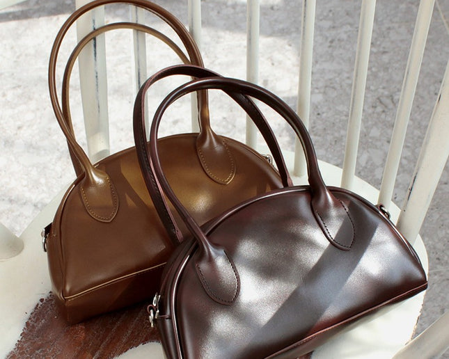 Two brown Korean handbags on a white chair. Made in Korea 
