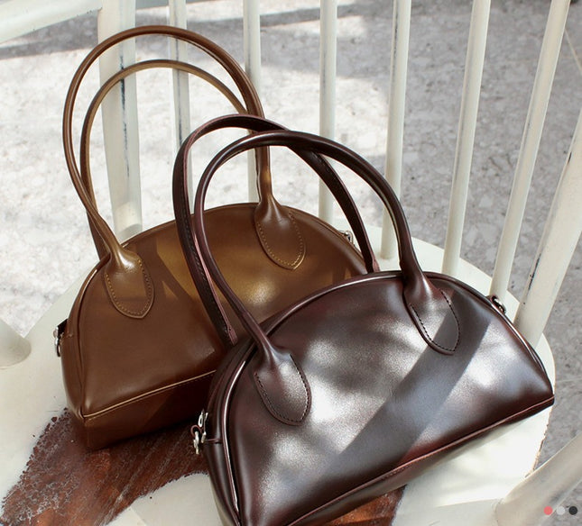 Two brown Korean handbags on a white chair. Made in Korea 